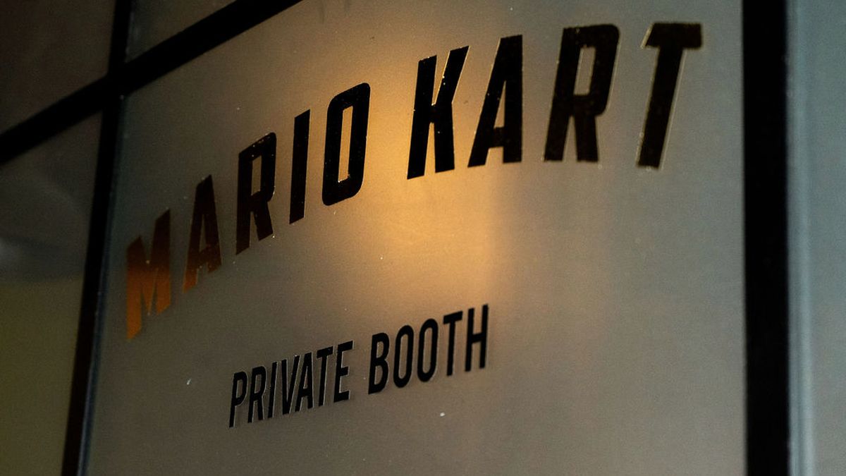 Etched glass door reading Mario Kart Private Booth